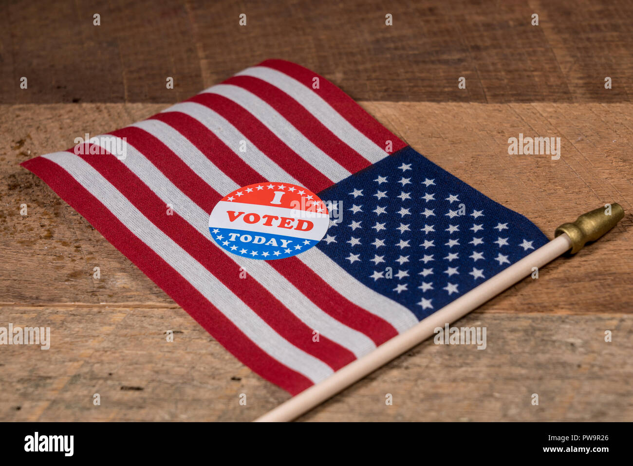I Voted Today paper sticker on US Flag and rural wooden table Stock Photo