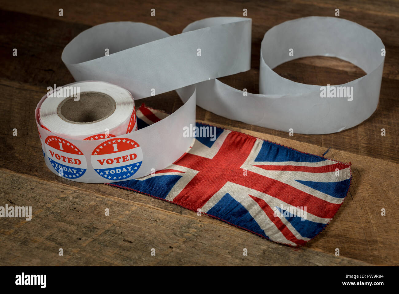 Roll of I Voted Today paper stickers on table with UK Flag Stock Photo