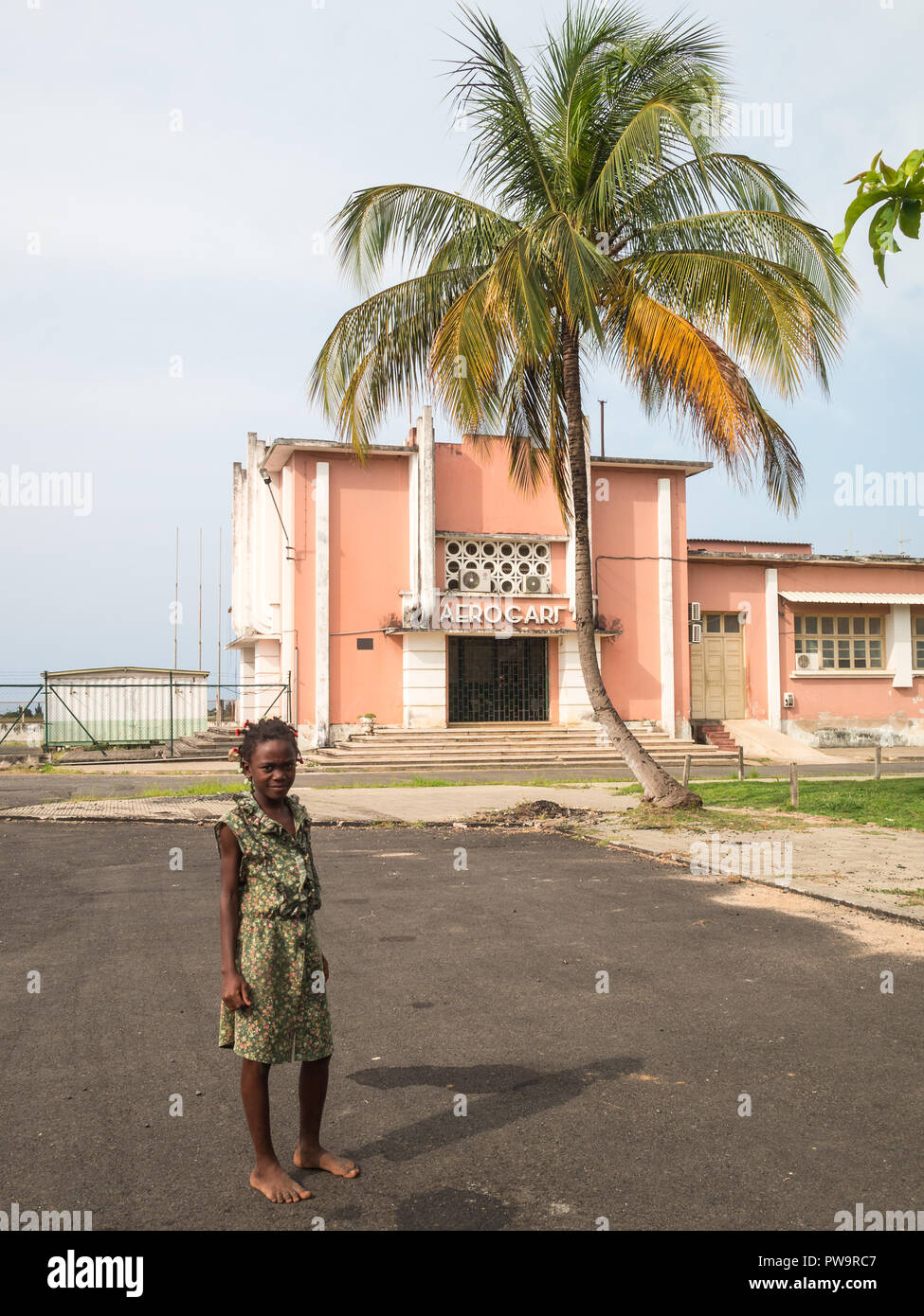 A girl by the old airport building in São Tome Island Stock Photo