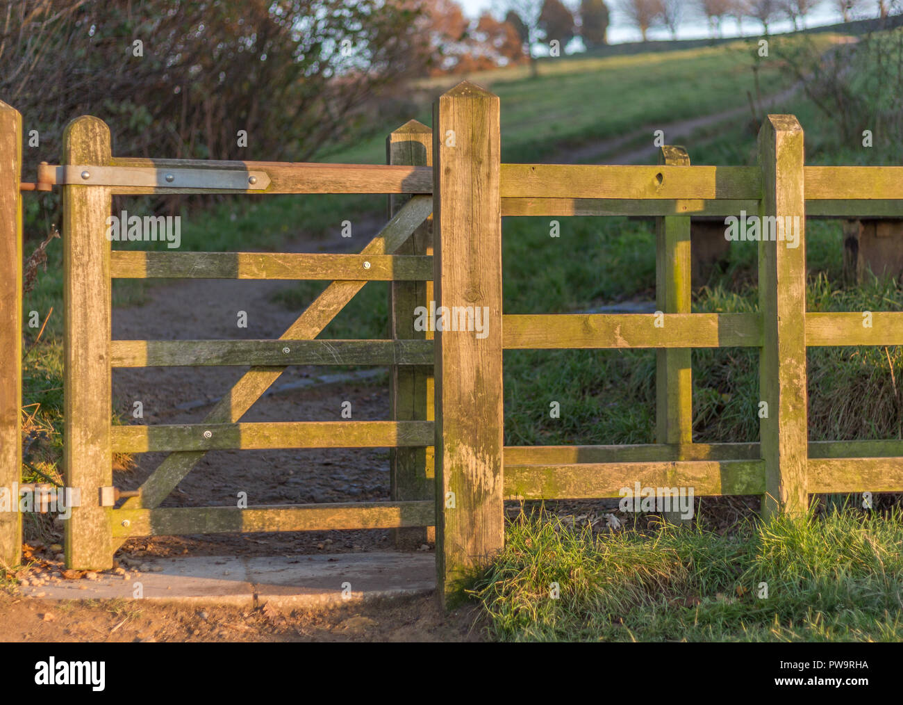 Traditional hinged wooden footpath gate in English countryside Stock Photo