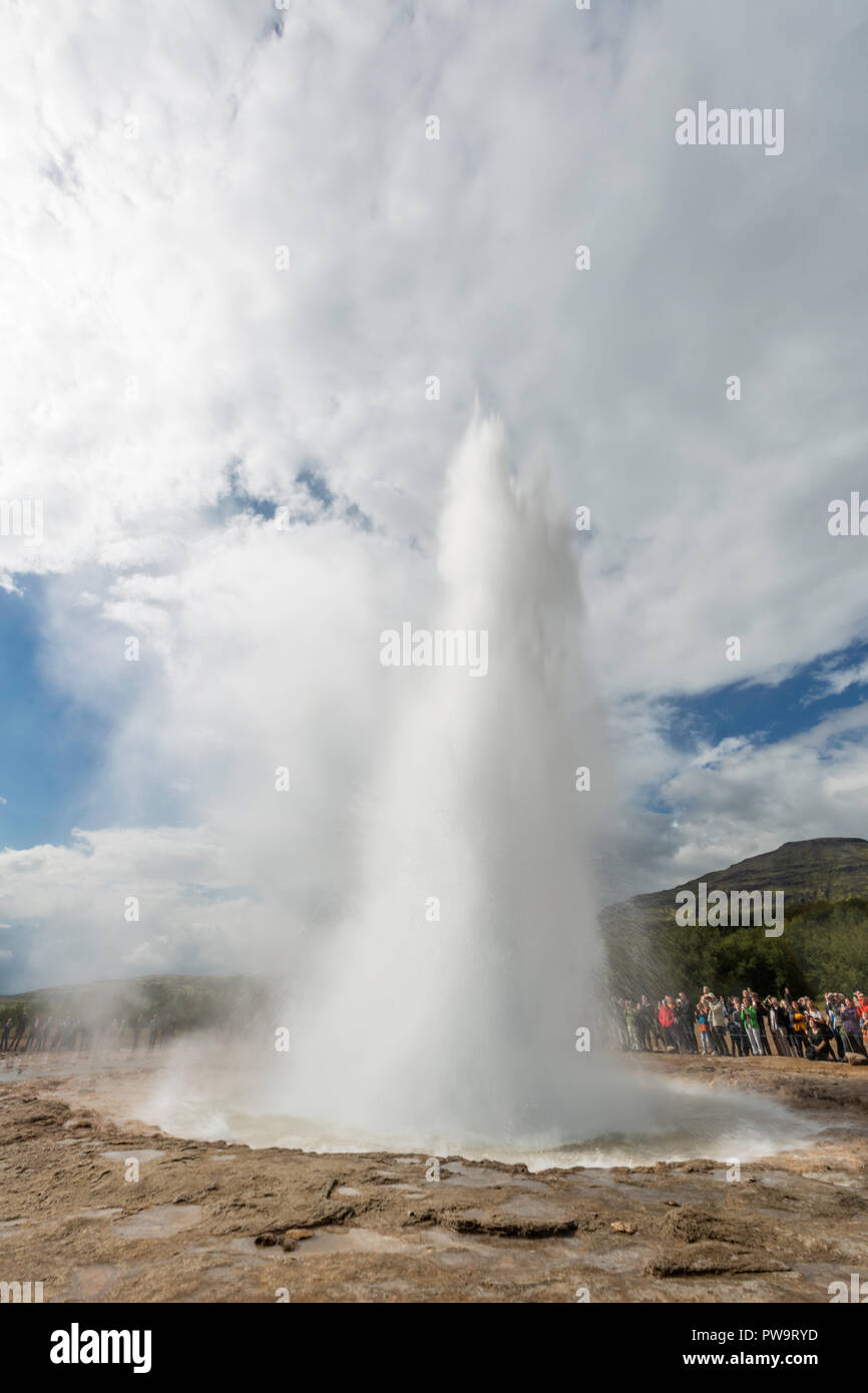 Tourists gather to watch Strokker geyser, 'geysir', an erupting spring at Haukadalur, Iceland Stock Photo