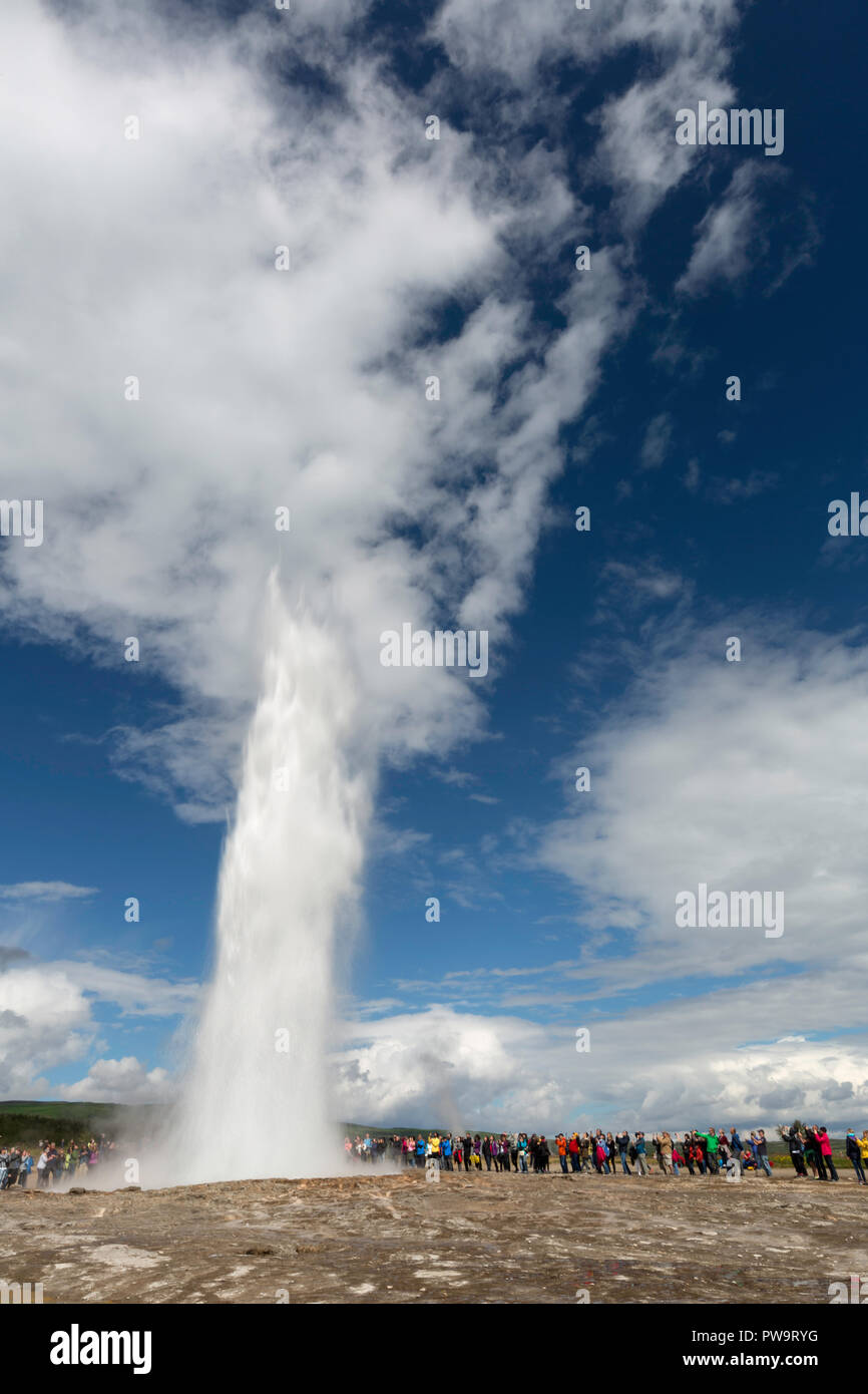 Tourists gather to watch Strokker geyser, 'geysir', an erupting spring at Haukadalur, Iceland Stock Photo