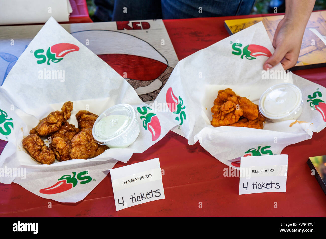 Miami Florida,Coconut Grove,Peacock Park,Great Taste of the Grove,community food Festival,festivals fair,taste,tasting,Chili’s,chicken wings,baskets,s Stock Photo