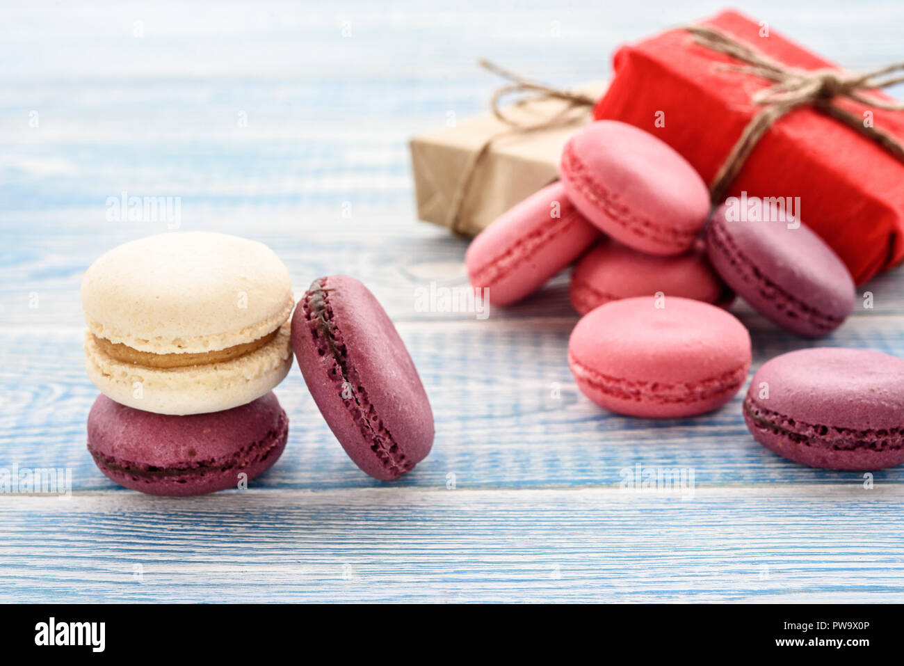 Sweet macarons on a blue  background. Trendy cakes. Stock Photo