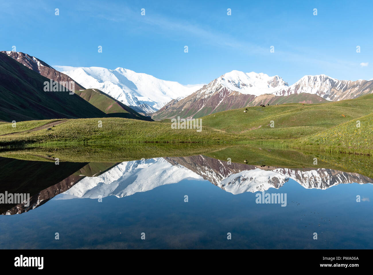 Peak Lenin mirrored in a mountain lake, Kyrgyzstan Stock Photo