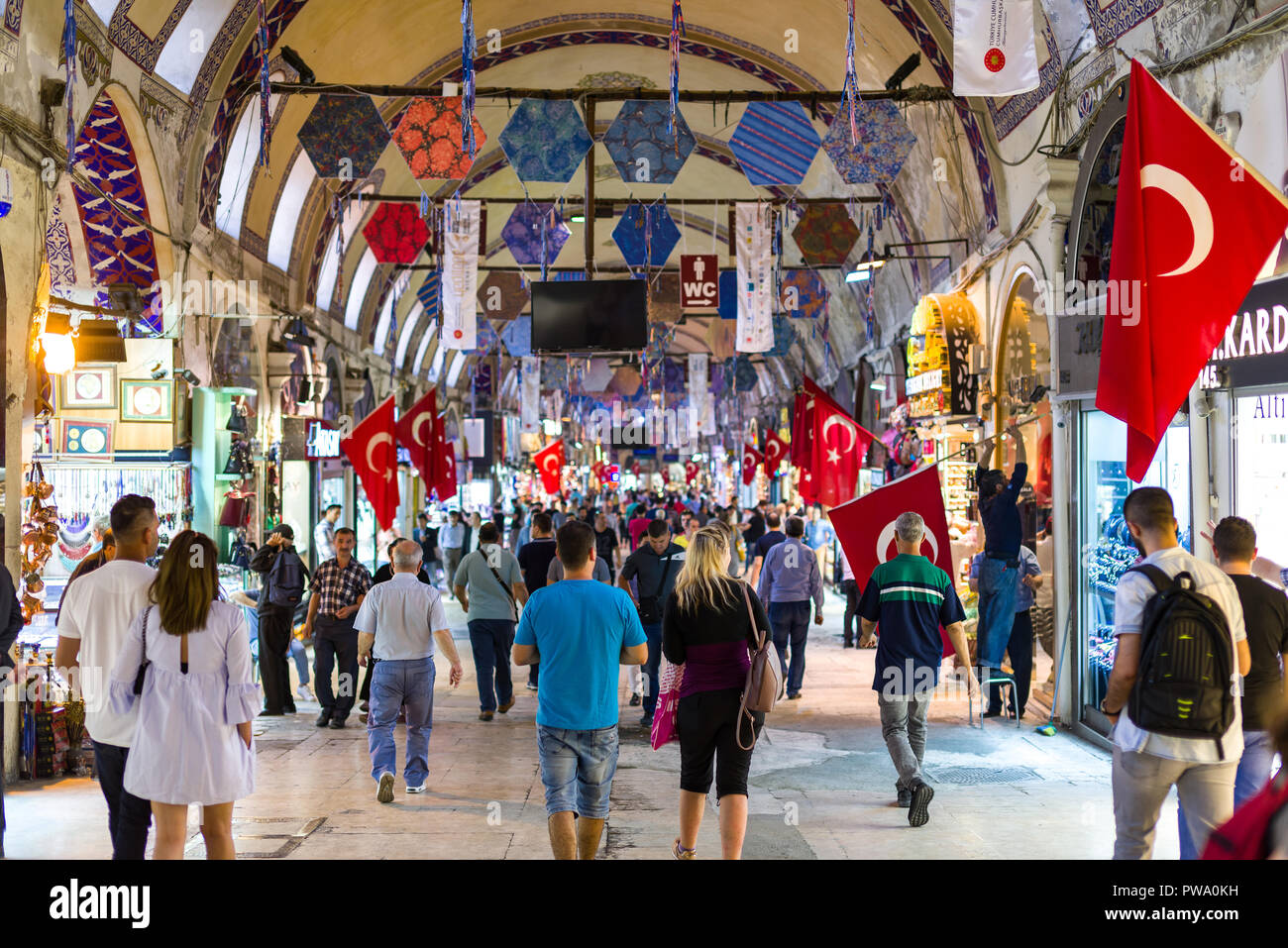 View of the Kapalı Çarşı or Grand Bazaar interior with people browsing items at the various small shops, Istanbul, Turkey Stock Photo