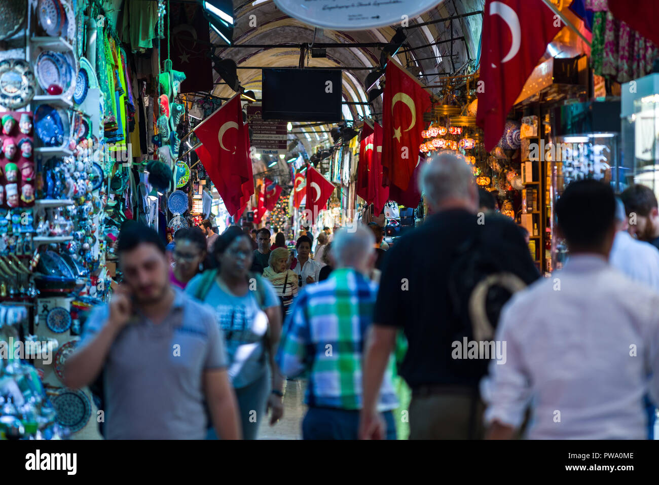 View of the Kapalı Çarşı or Grand Bazaar interior with people browsing items at the various small shops, Istanbul, Turkey Stock Photo