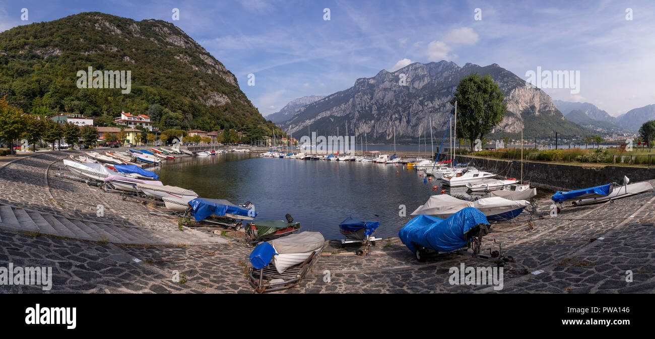 Boats at Valmedrera harbour on Lake Como, Italy, with mountains Stock Photo