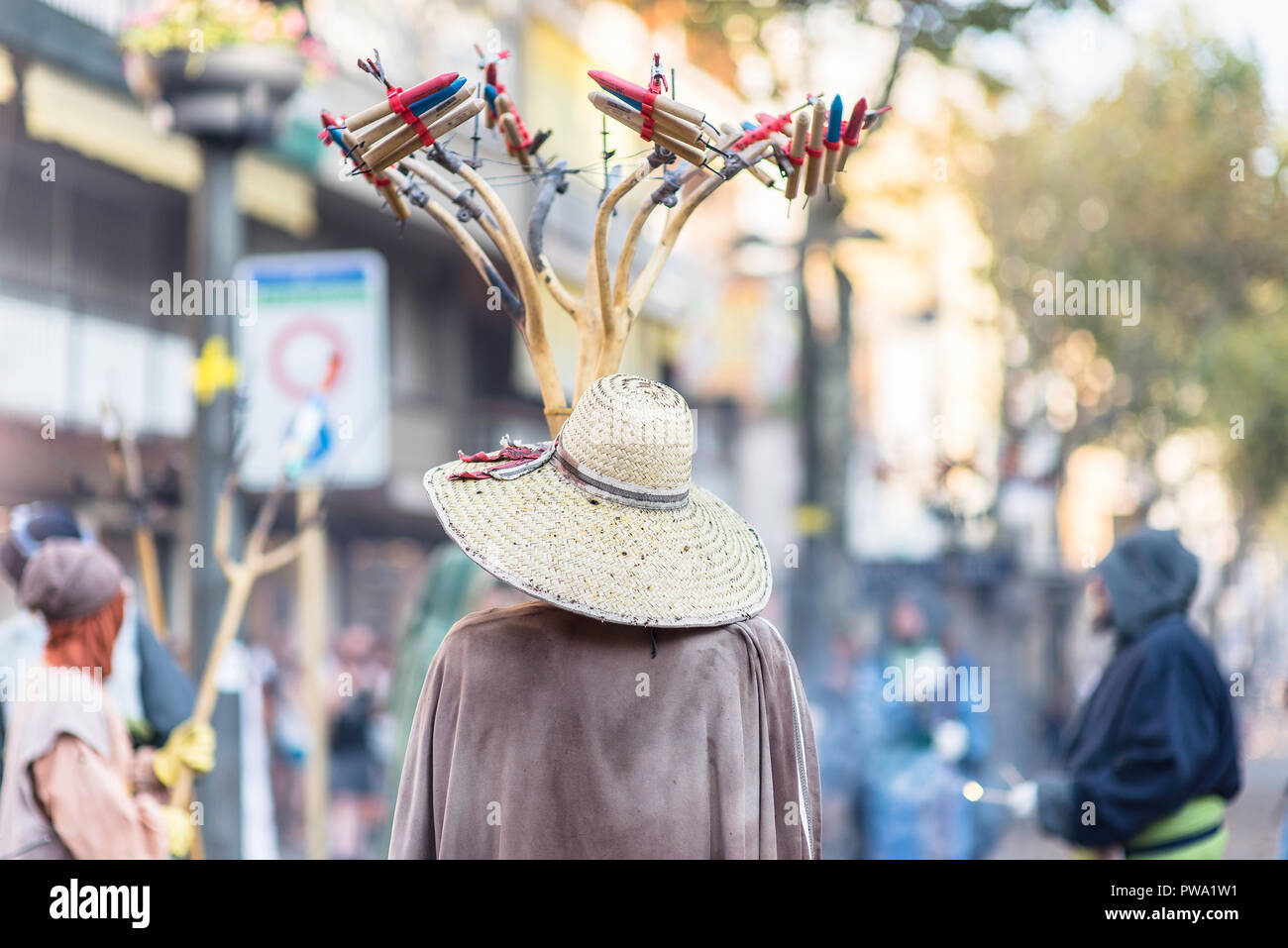 Man with a costume wearing a hat full of firecrackers during the Festa Major in Vilanova I la Geltru'. Barcelona, Catalonia. August 2018 Stock Photo