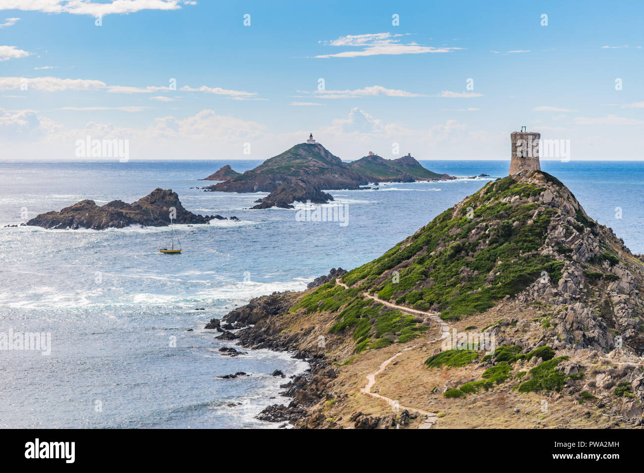 View of Pointe de la Parata on the west coast of Corsica. A ruined Genoese tower sits on top of the rocky promontory overlooking the Sanguinaires. Stock Photo