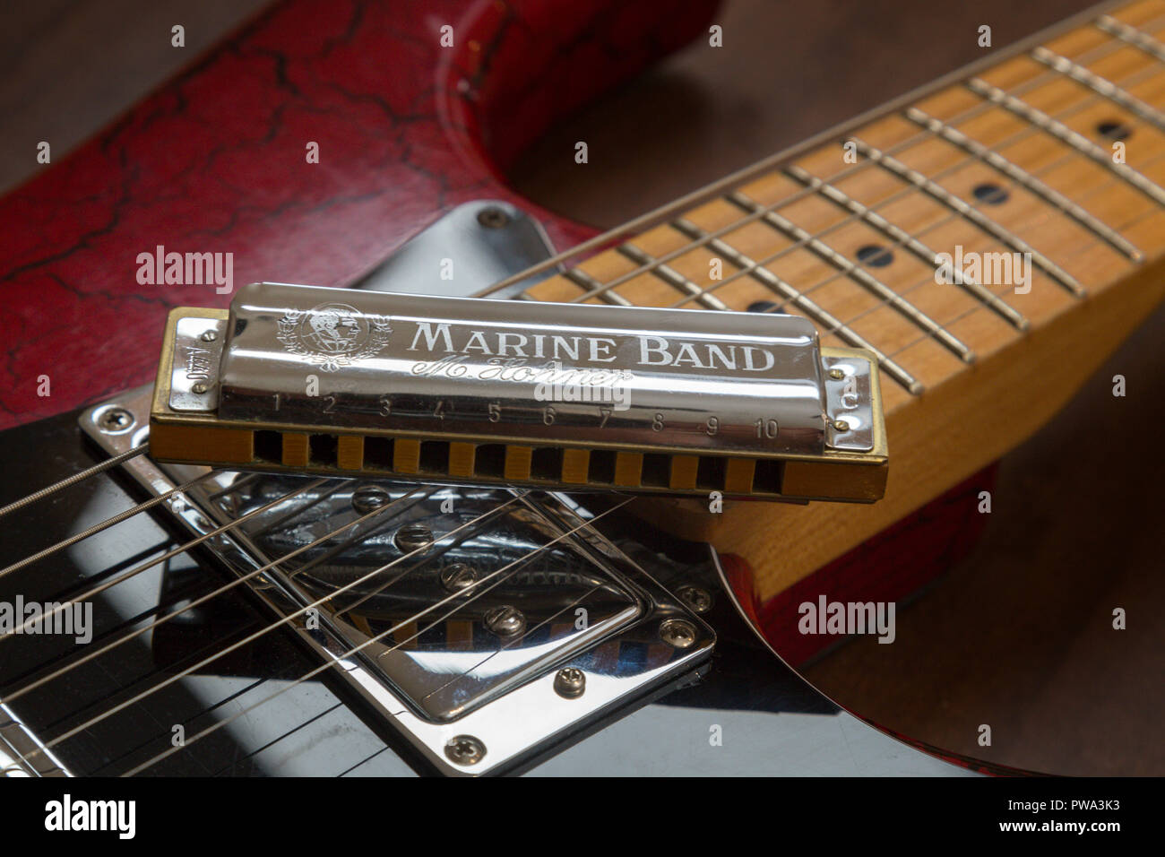 Old electric guitar and harmonica, Hohner Marine Band Stock Photo ...