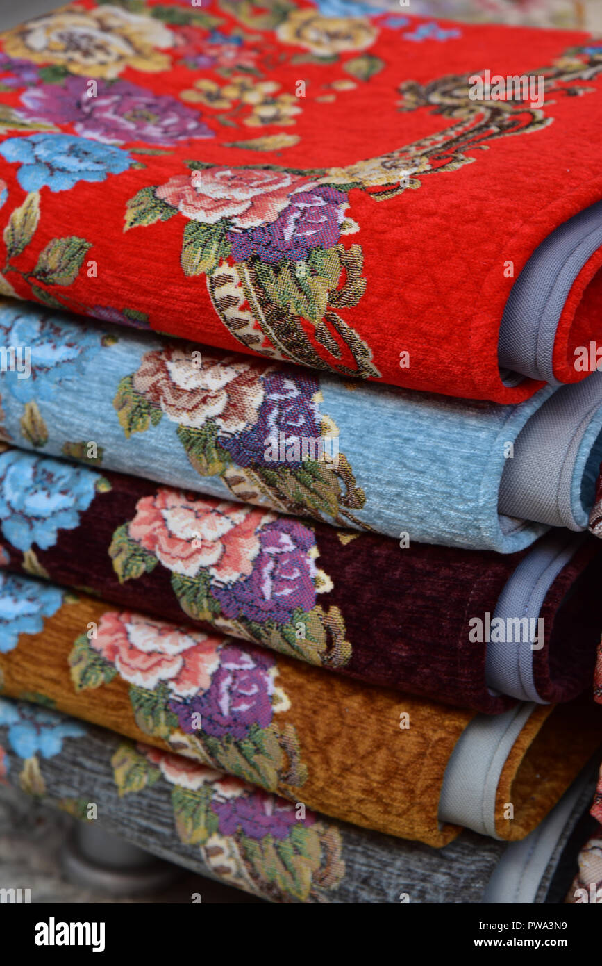 Colourful floral carpets for sale inside the Grand Bazaar, Istanbul, Turkey, Europe. Stock Photo