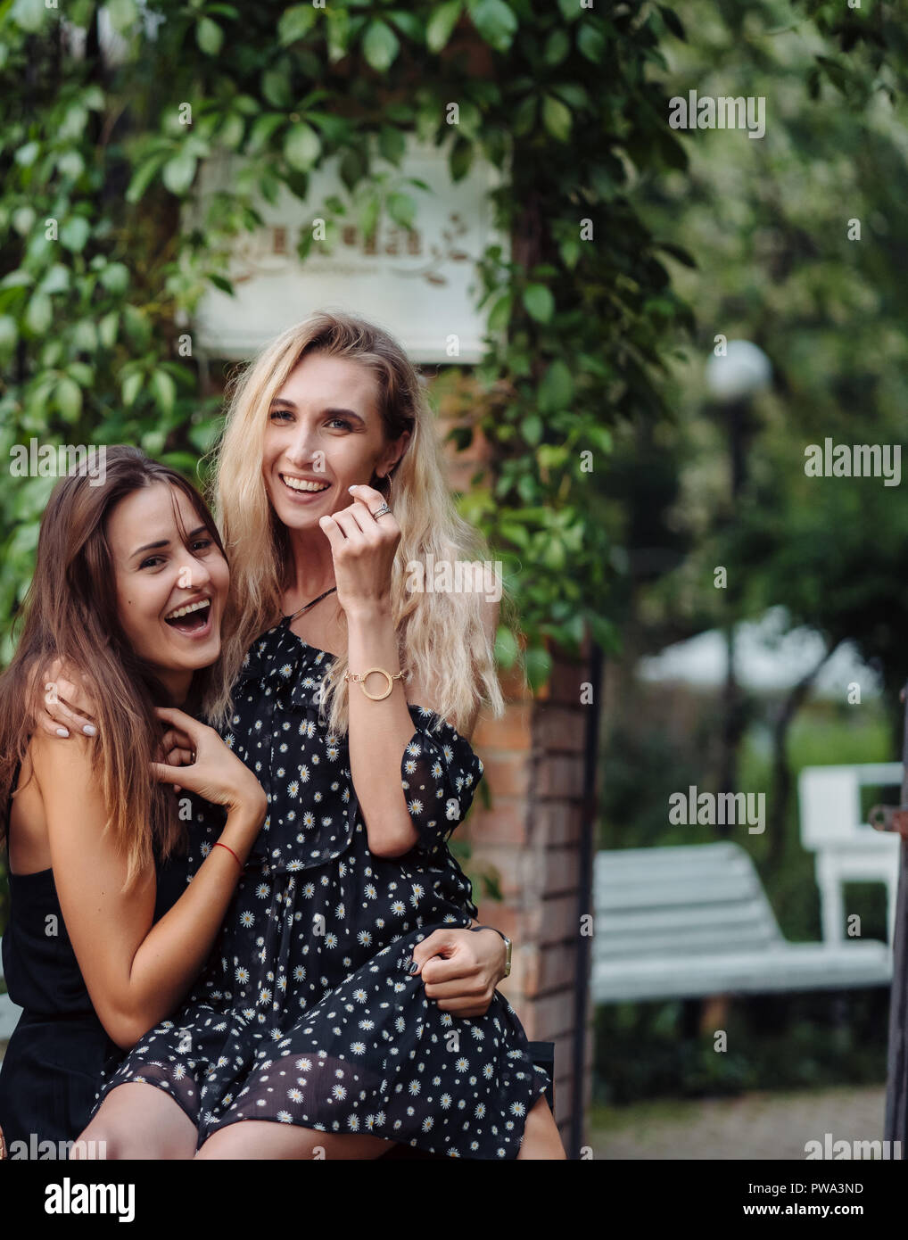 Two beautiful girls in the park posing on the camera Stock Photo - Alamy