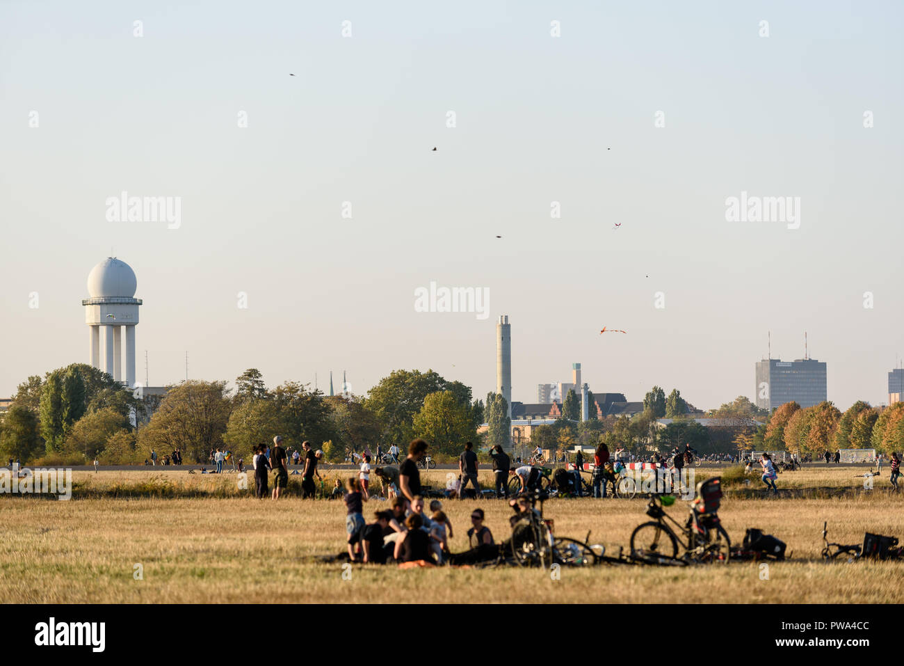 Visitors are seen on the Tempelhor field. The good weather in October brings many visitors to the park at the former Tempelhof Airport. Stock Photo