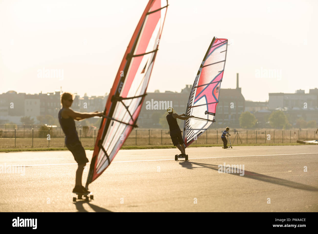 Wind skaters are at the Tempelhofer field. The good weather in October brings many visitors to the park at the former Tempelhof Airport. Stock Photo