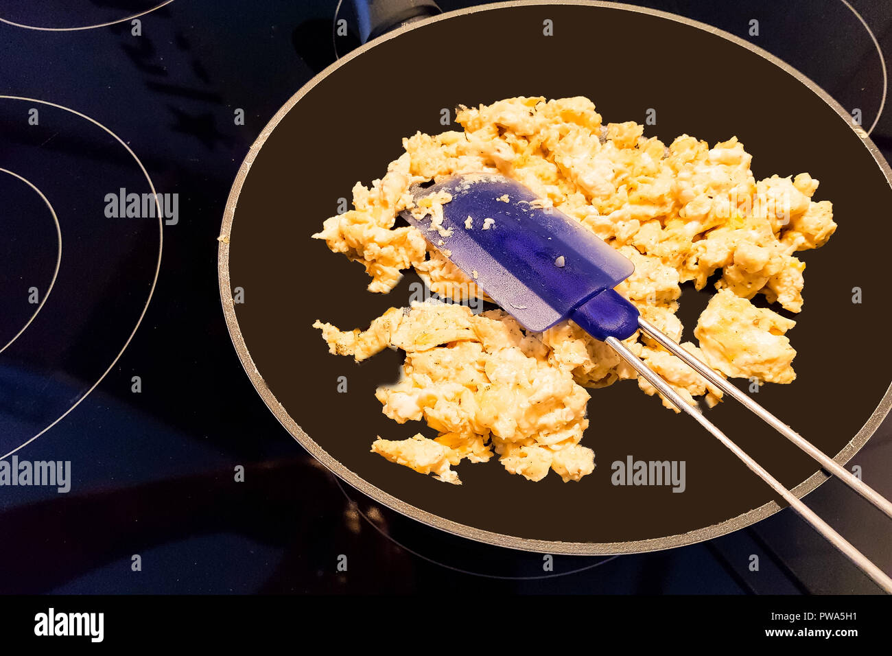 Scrambled eggs in a pan on an induction hob Stock Photo Alamy