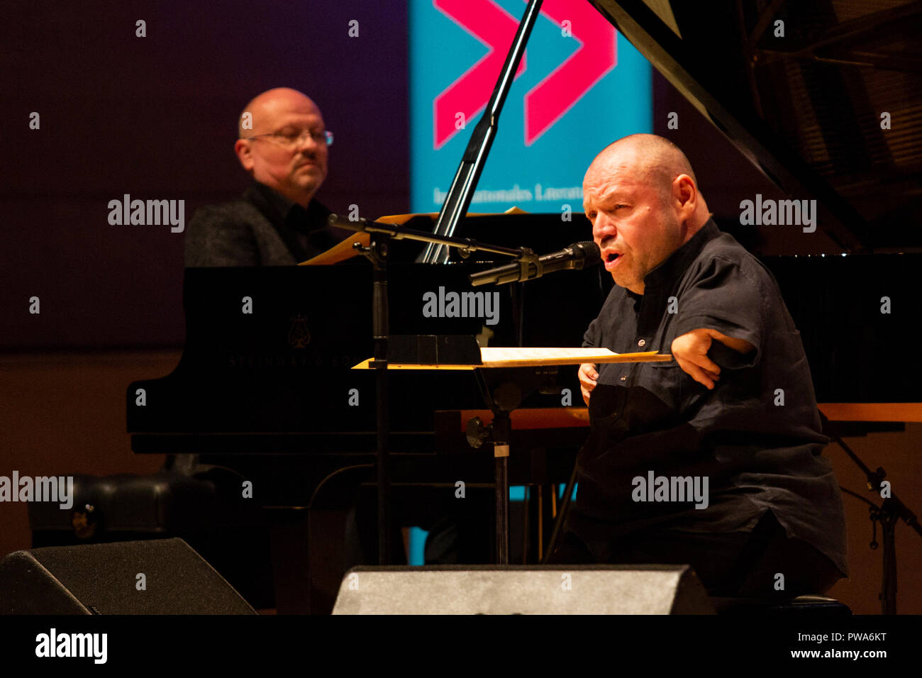 Essen, Germany. 10 October 2018. Musicians Frank Chastenier and Thomas Quasthoff perform at the reading of 'Die buckelige Verwandtschaft' performed by three generations of the Thalbach Family: Katharina Thalbach, Nellie Thalbach and Anna Thalbach. The second lit.RUHR literature festival takes place from 9 to 14 October 2018 with more than 80 events in the Ruhr Area. Stock Photo