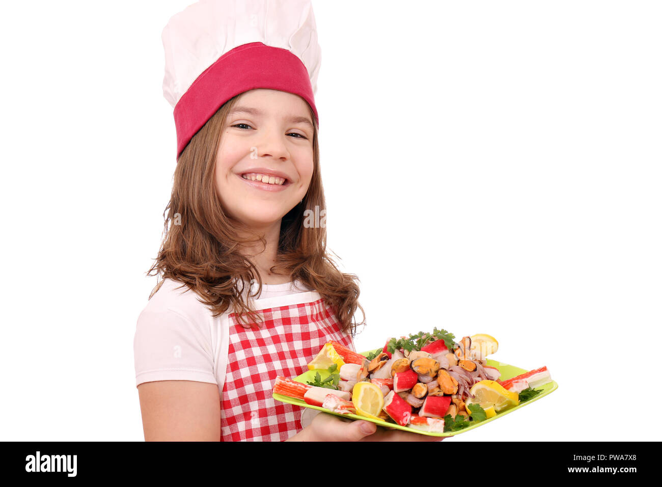 happy little girl cook with seafood on plate Stock Photo