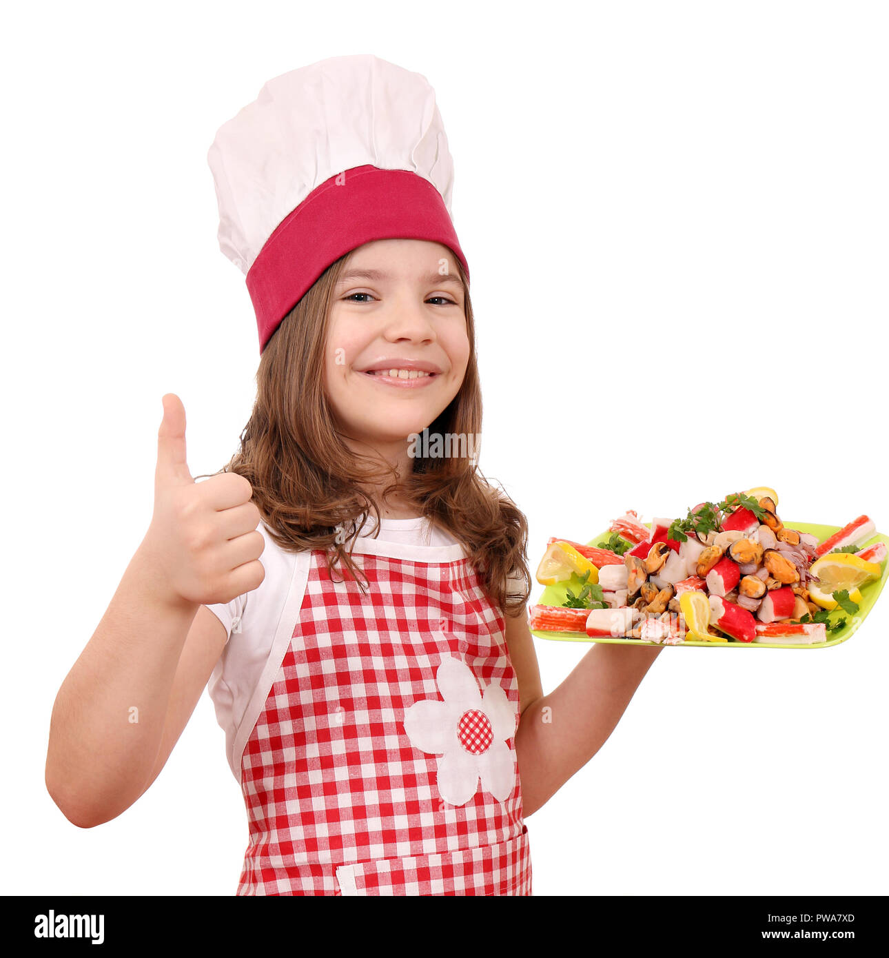 happy smiling little girl cook with seafood and thumb up Stock Photo