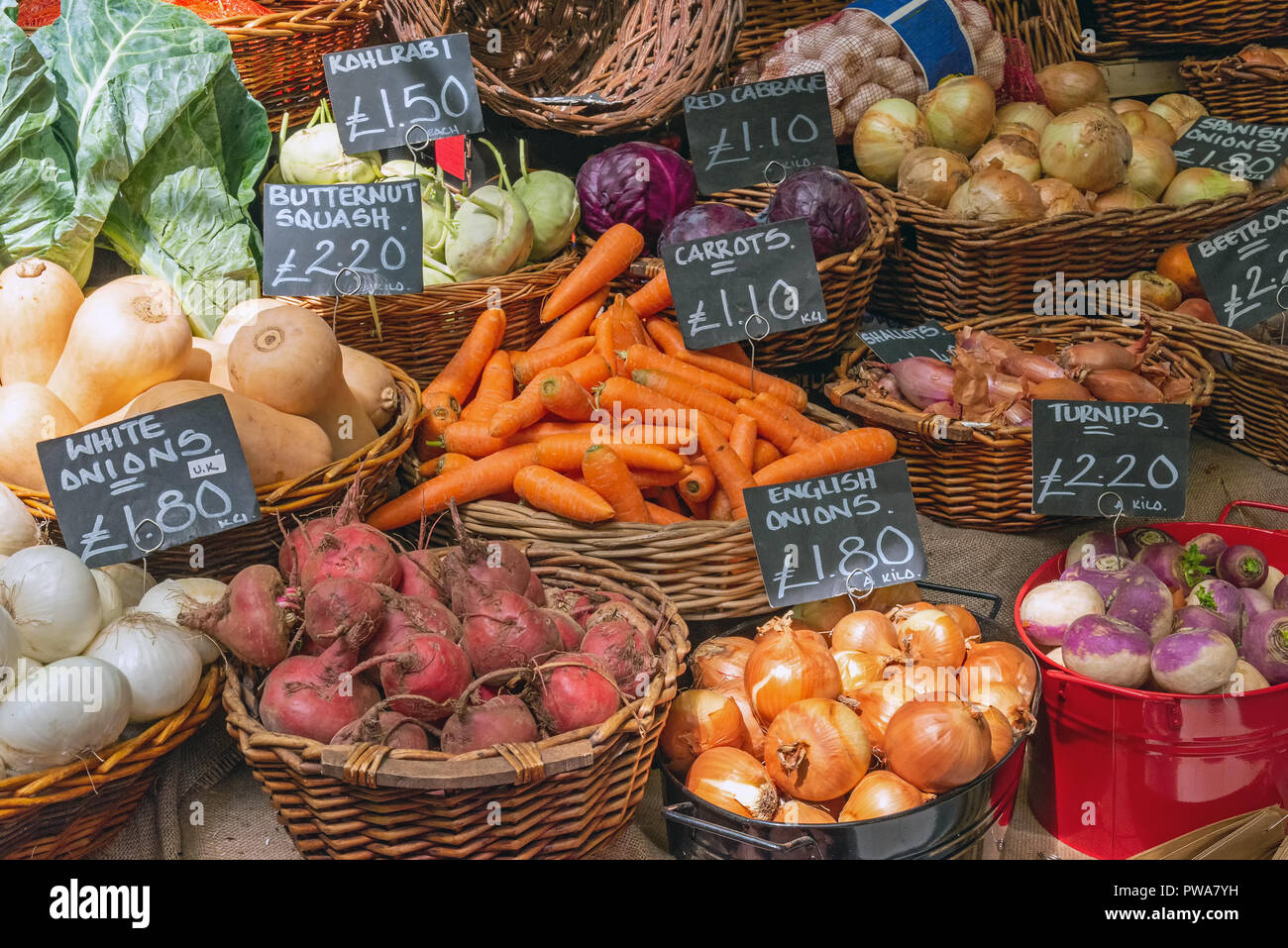Onions, carrots and other vegetables for sale at a market in London Stock Photo