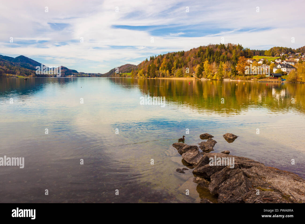 Alpine lake Fuschlsee in austrian Alps on sunny autumn day. Beautiful view from Fuschl am See town, Austria. Stock Photo