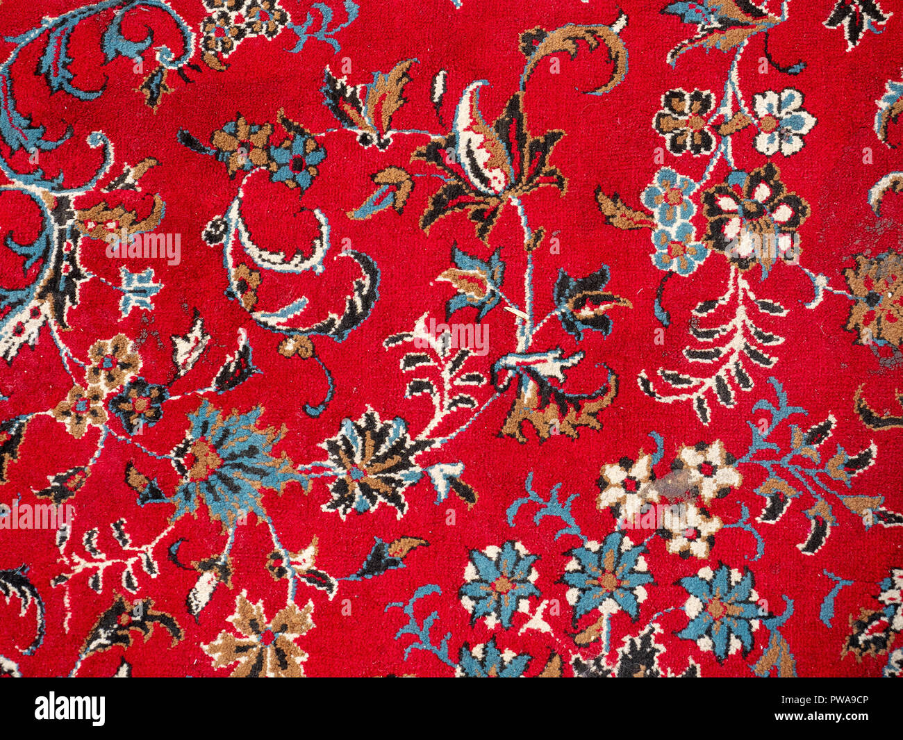 Red persian rug close up with floral design Stock Photo