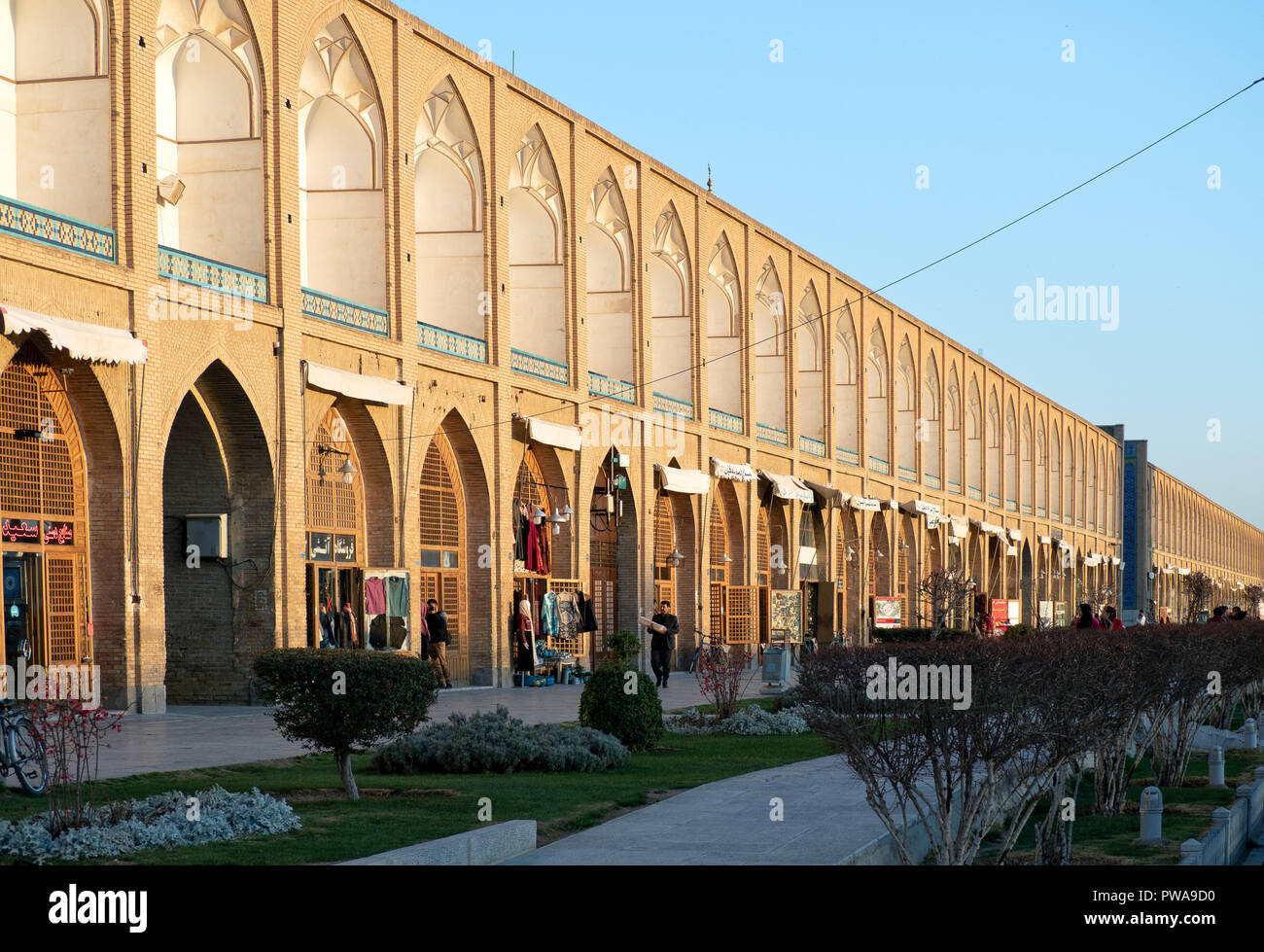 Isfahan, Iran - March 4, 2017 : Souvenir shops in Naqsh-e Jahan Square at sunset. Also known as Meidan Emam, it is now a popular tourist attraction Stock Photo