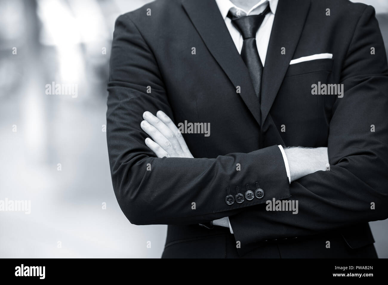 Gentleman business man cross arm vintage black and white monotone Stock Photo