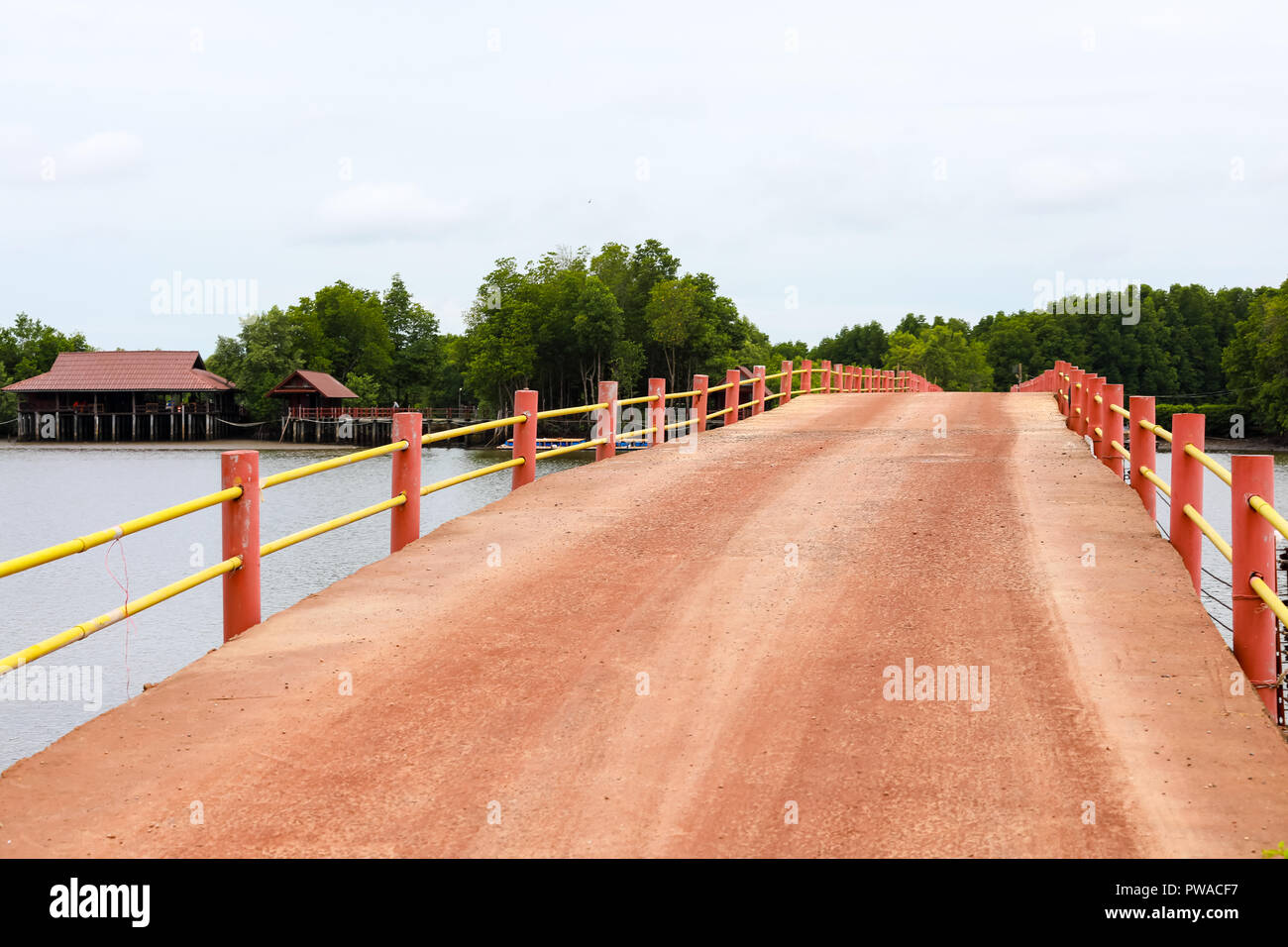 Old reddish brown concrete bridge cross over swamp area located at ...