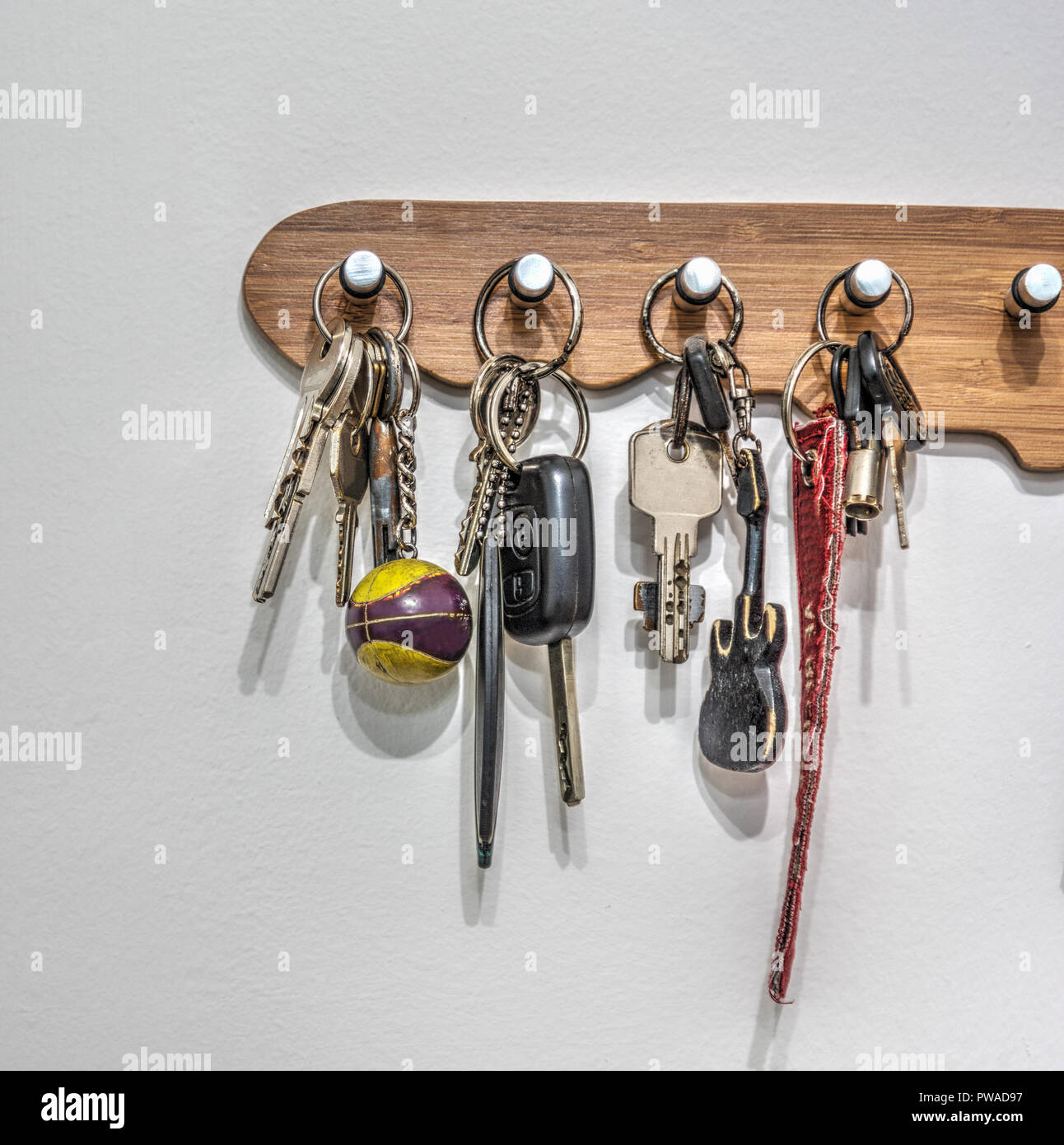 Key holder with keys hanging on the wall Stock Photo - Alamy
