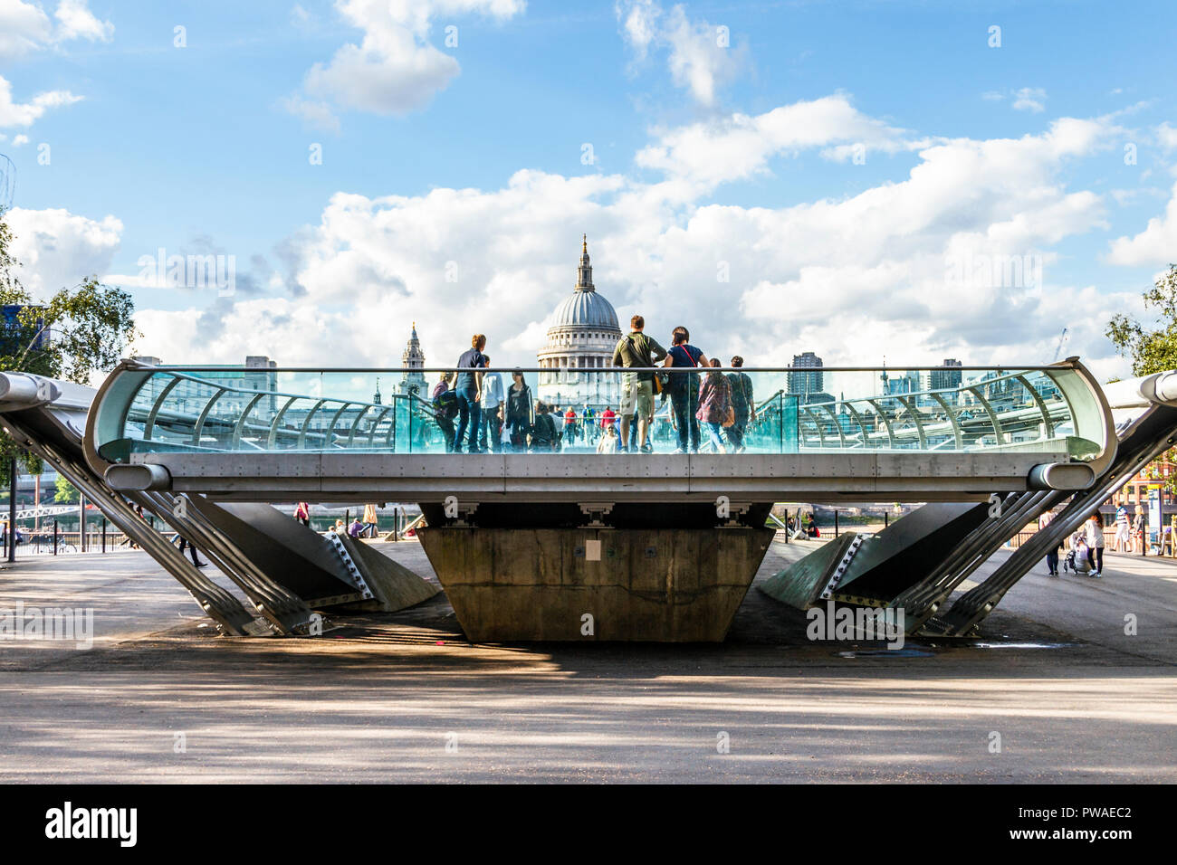 Tourist at the Bankside end of the Millennium Bridge, London, UK, St Paul's Cathedral in the background Stock Photo