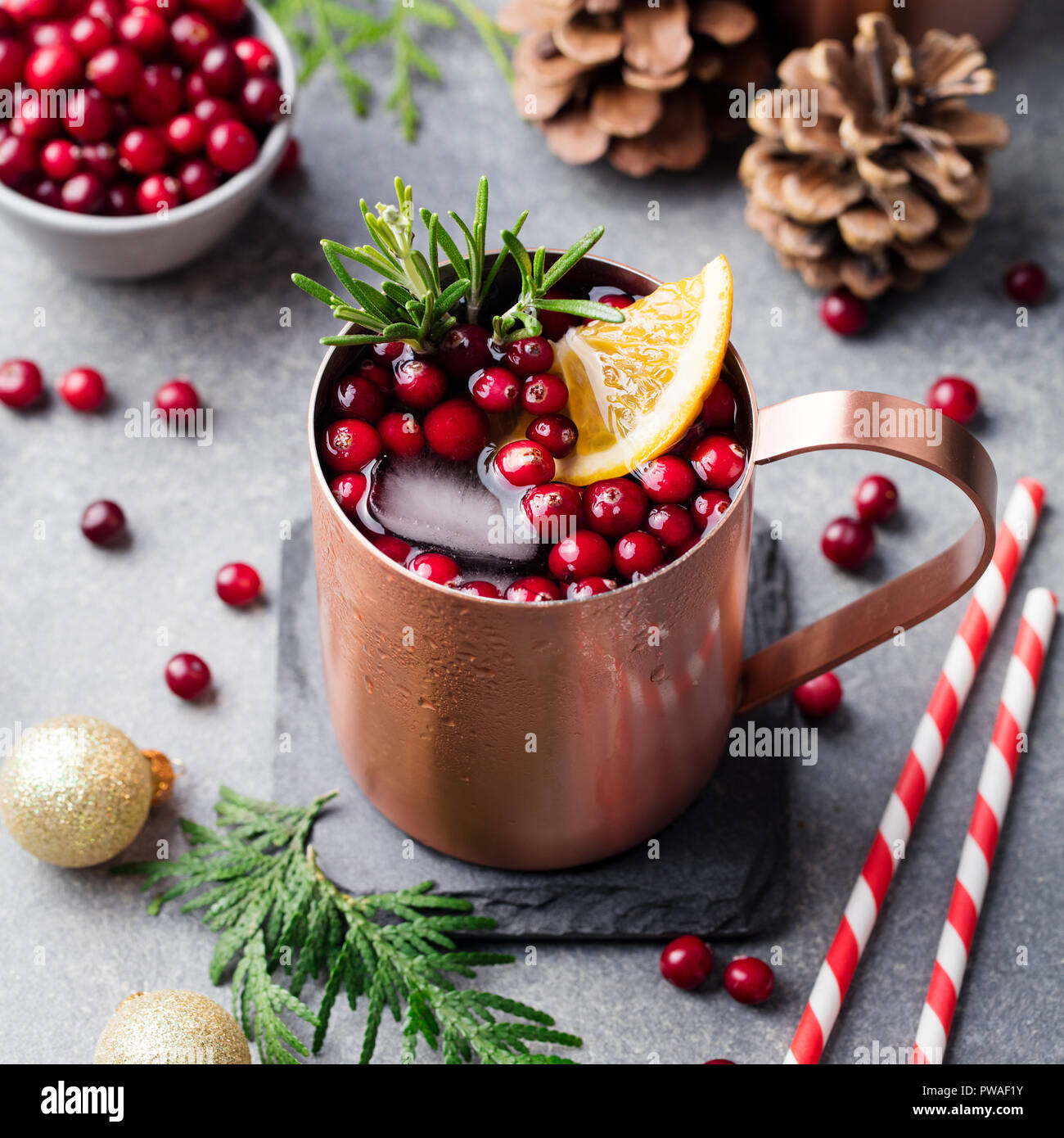 Christmas Moscow mule, holiday drink in a copper mug. Grey stone