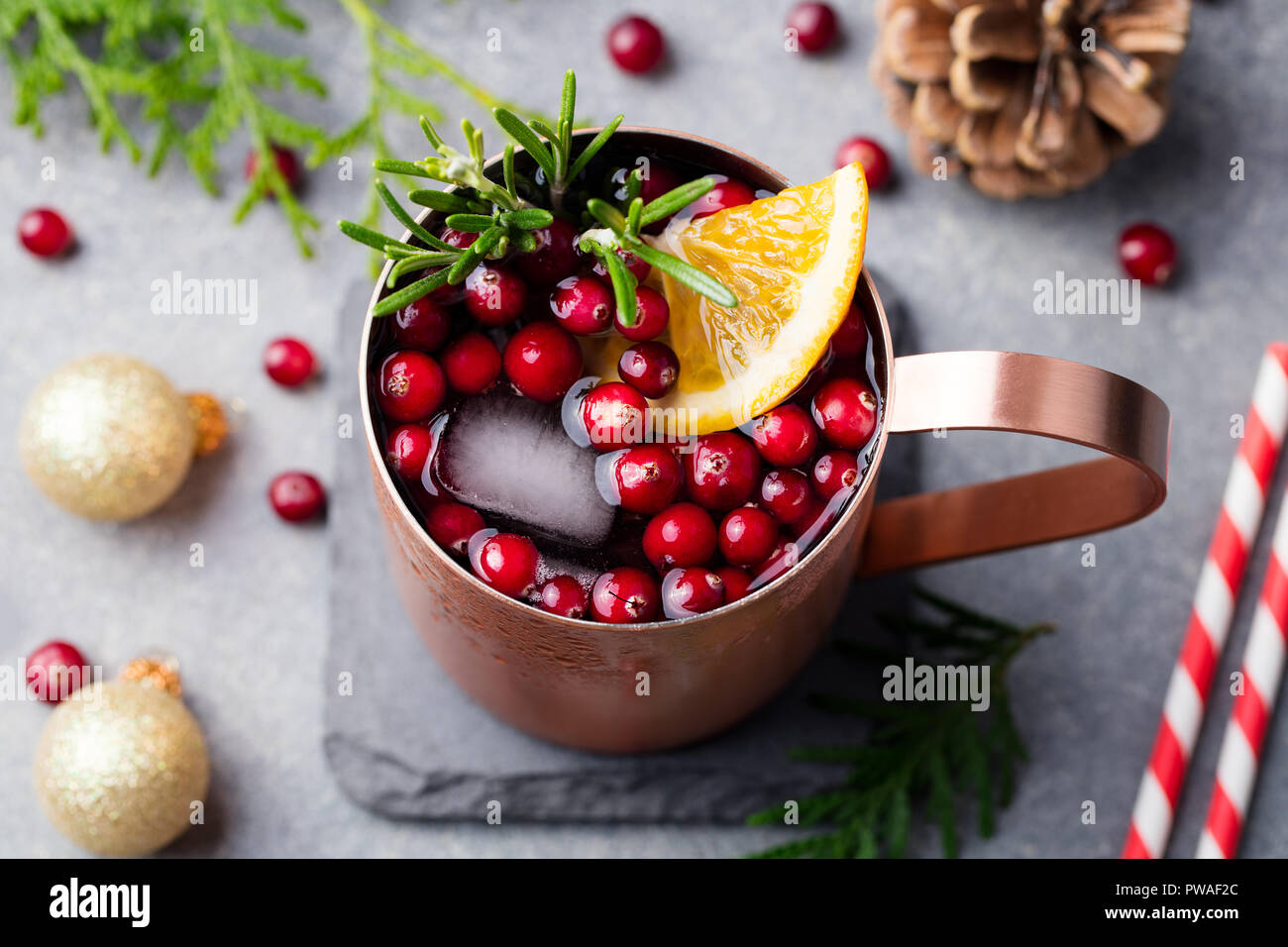 Christmas Moscow mule, holiday drink in a copper mug. Grey stone