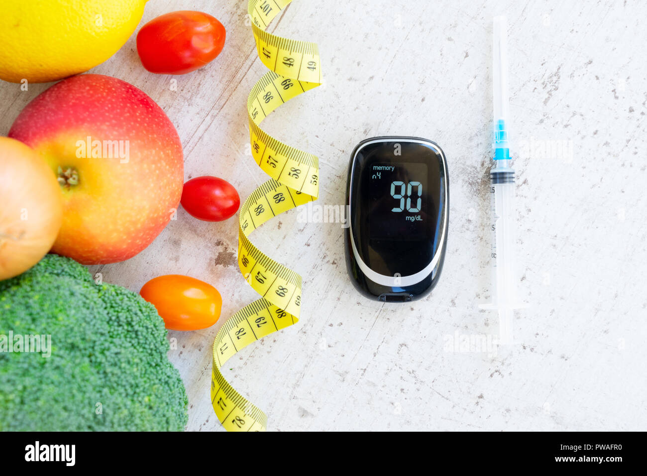 Diabetes healthy diet concept, raw vegetables with blood glucose meter