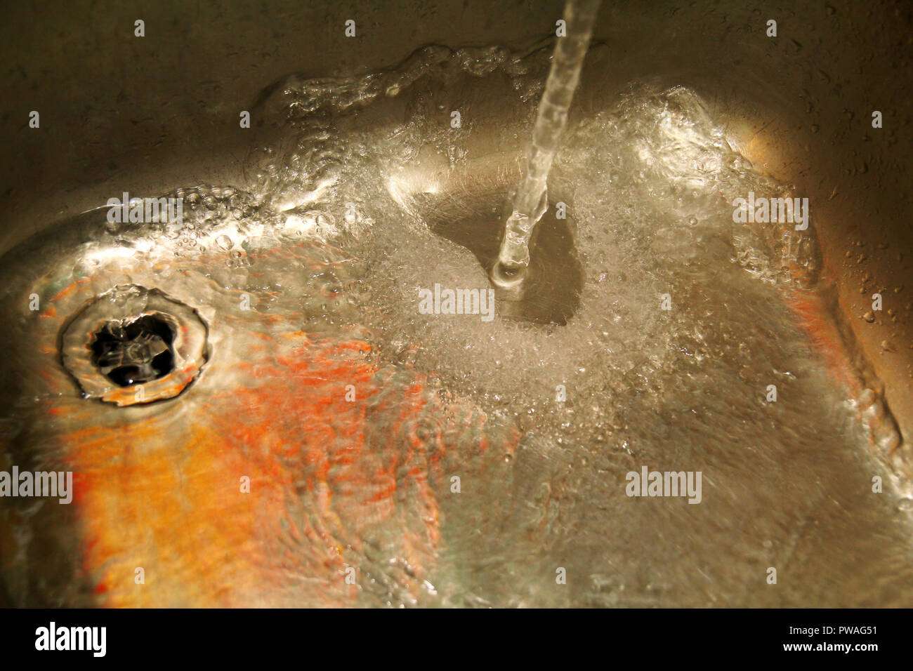 Water splashing down in the sink, close up. Scene water splashing