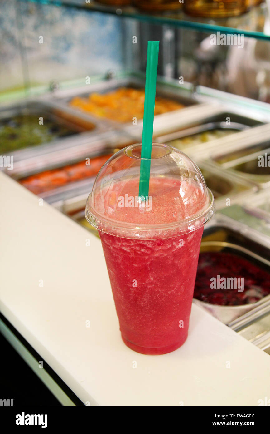 Fruit smoothie ready for sales in plastic cup with straw. Take away