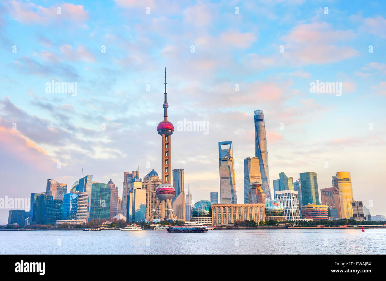 Colorful sunset over Shanghai metropolis embankment with buildings of modern architecture, skyscrapers and famous tv tower, China Stock Photo