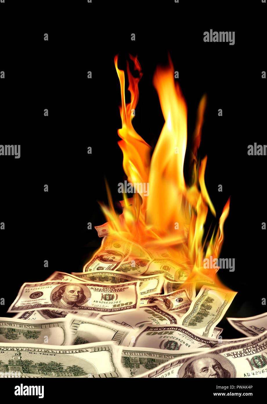 Conceptual finance image of burning pile of money, dollar bills, and fire flames in black background Stock Photo