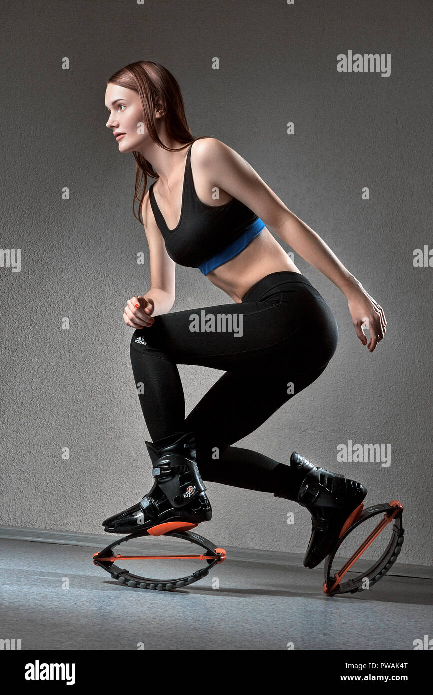 woman in kangoo jumping shoes exercising on pink background, athletic body,  fitness trend, balance Stock Photo - Alamy