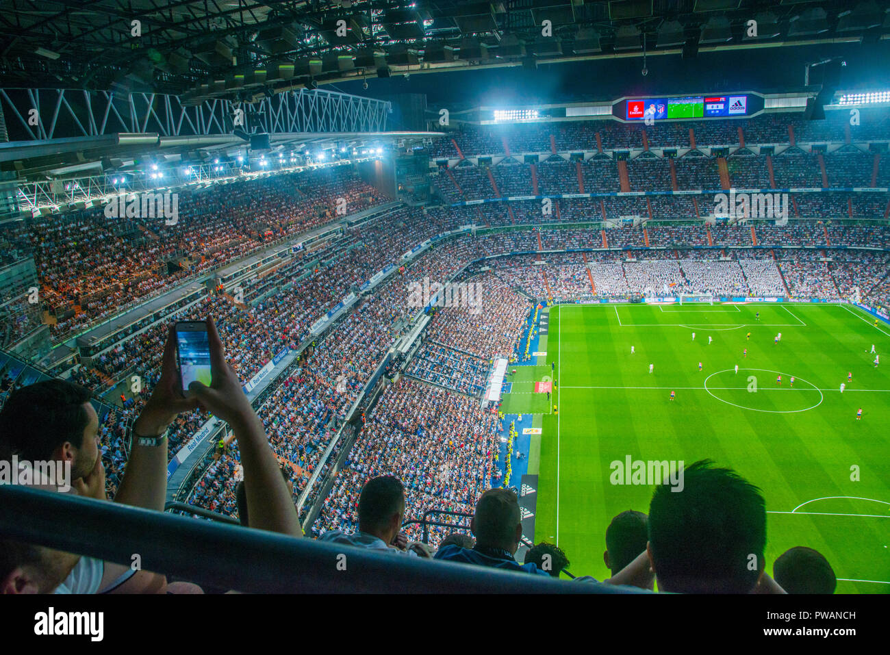 Spectators during football match. Santiago Bernabeu stadium, Madrid, Spain. Stock Photo