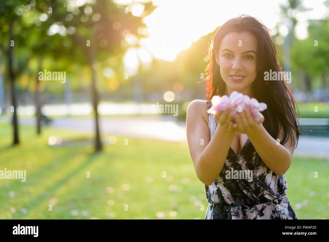 Young beautiful Hispanic woman relaxing in the park Stock Photo