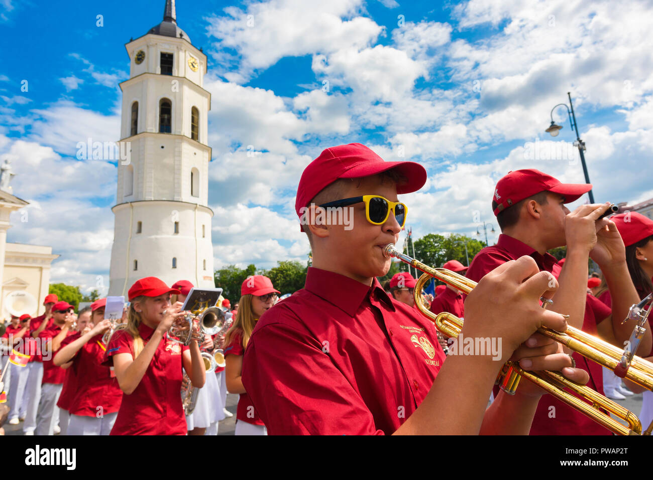 Vilnius festival, view of a young people's marching band parading through Cathedral Square in the Lithuanian Song and Dance Festival, Vilnius Old Town. Stock Photo