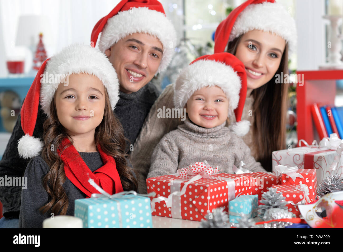 Portrait of family in Santa hats preparing for Christmas Stock Photo