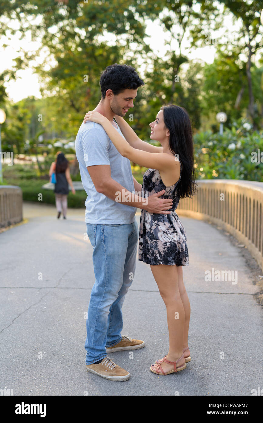 Young Hispanic couple relaxing in the park together Stock Photo