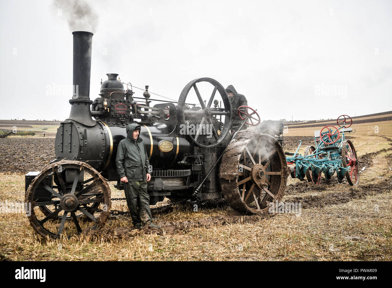 A steam pulled plough takes a break after soggy weather makes turning heavy traction engines difficult in the soft mud during the 68th British National Ploughing Championships at Austrey, near Atherstone, Warwickshire, where more than 250 ploughmen and women from all over Britain are taking part. Stock Photo