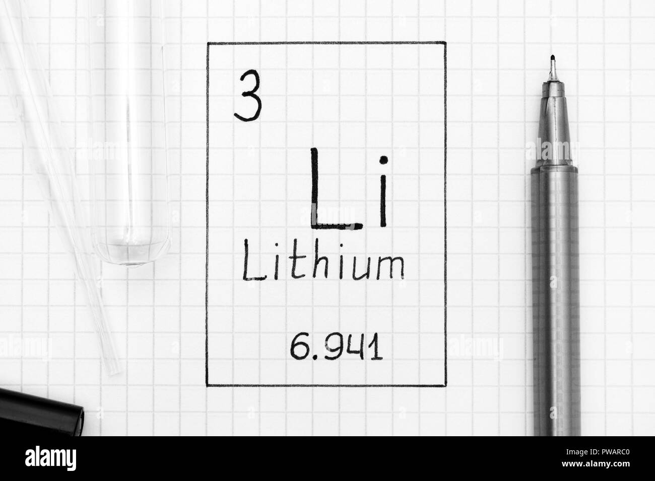 The Periodic table of elements. Handwriting chemical element Lithium Li with black pen, test tube and pipette. Close-up. Stock Photo