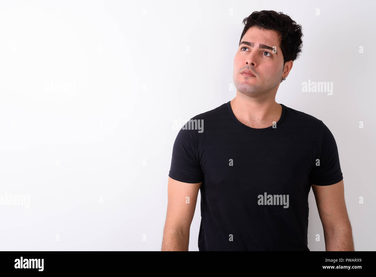 Young handsome Persian man against white background  Stock Photo