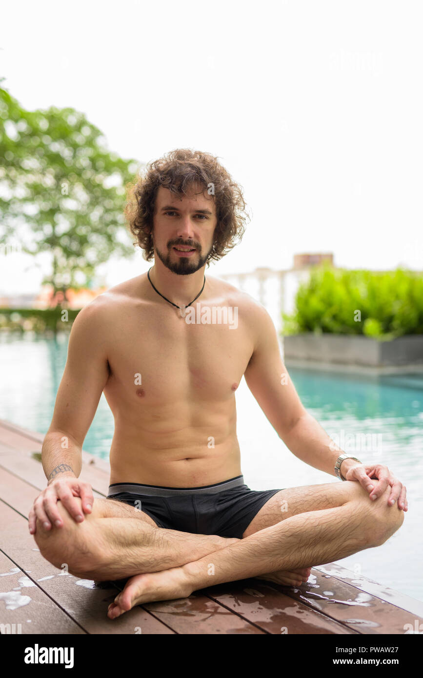 Handsome Bearded Man Shirtless Relaxing Beside The Swimming Pool