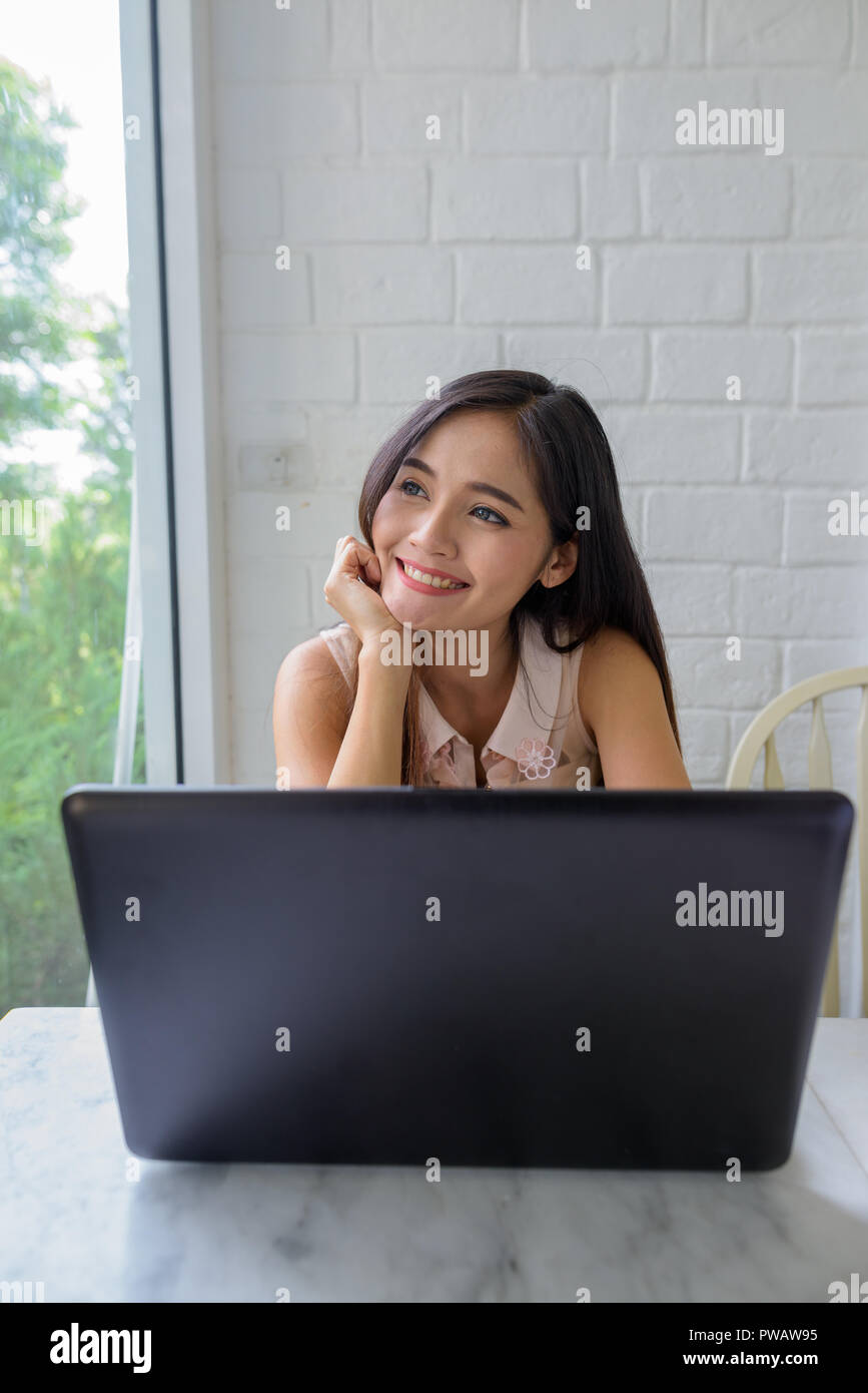Young beautiful Asian woman relaxing at the coffee shop Stock Photo - Alamy