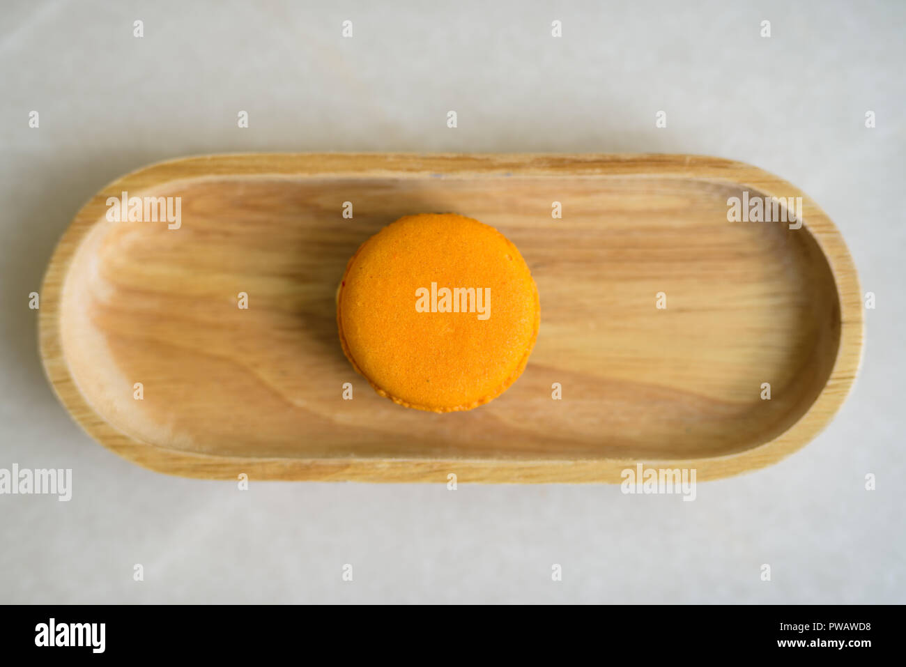Directly Above Shot Of Orange Macaroon Served On Table Stock Photo